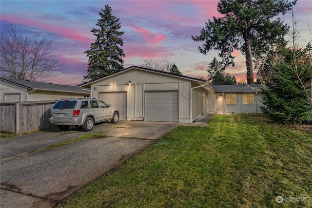 ranch-style home with a lawn and a garage