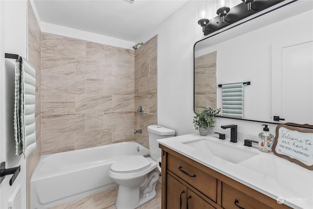 full bathroom featuring toilet, vanity, and tiled shower / bath