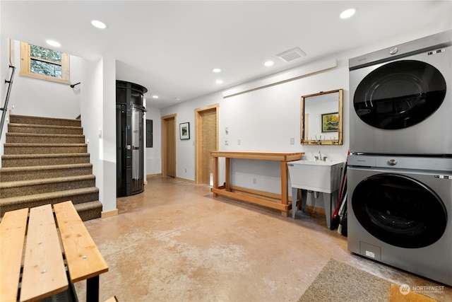 clothes washing area with stacked washer / drying machine