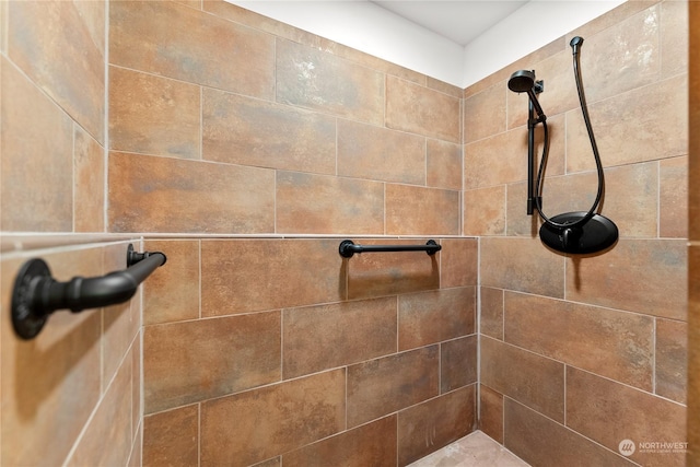 interior details with a tile shower