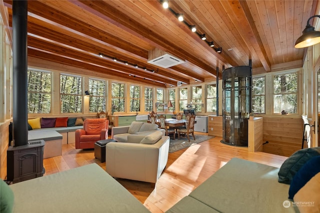 sunroom / solarium with beamed ceiling, wooden ceiling, and rail lighting