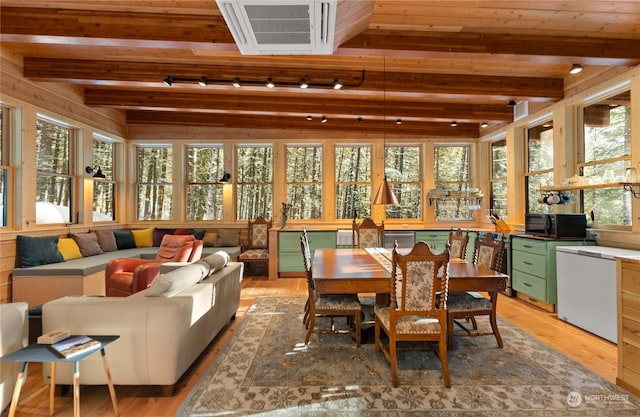 sunroom featuring beam ceiling