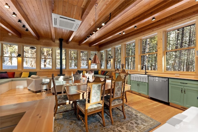 dining space with sink, light hardwood / wood-style flooring, a wall mounted AC, beam ceiling, and wood ceiling