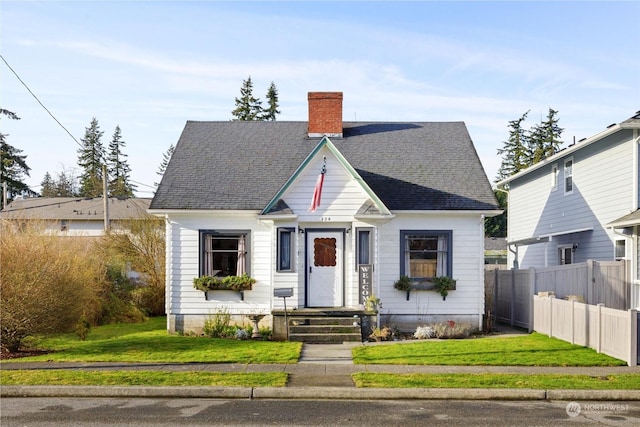 bungalow-style home featuring a front yard