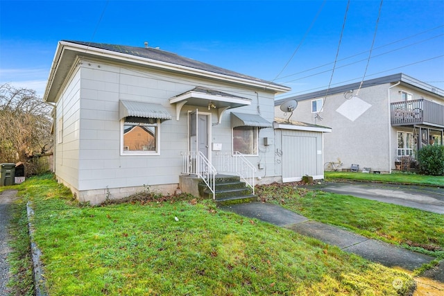 bungalow-style home featuring a front yard