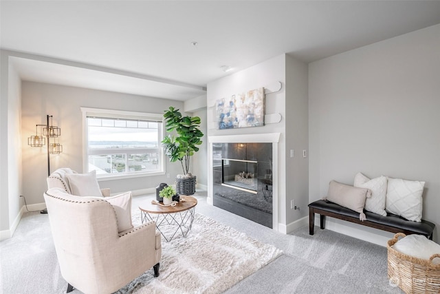 living room with light carpet and a tiled fireplace