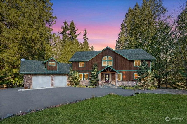 view of front of house featuring a garage and a yard