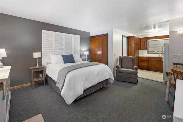 carpeted bedroom featuring sink and white refrigerator