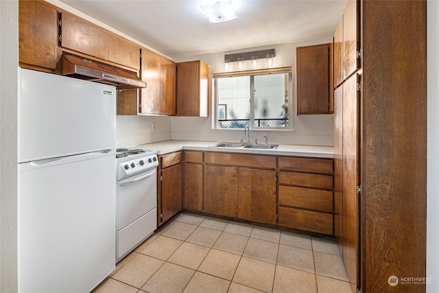 kitchen with light tile patterned floors, white appliances, sink, and range hood