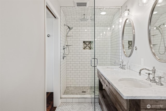 bathroom featuring tile patterned flooring, vanity, and an enclosed shower