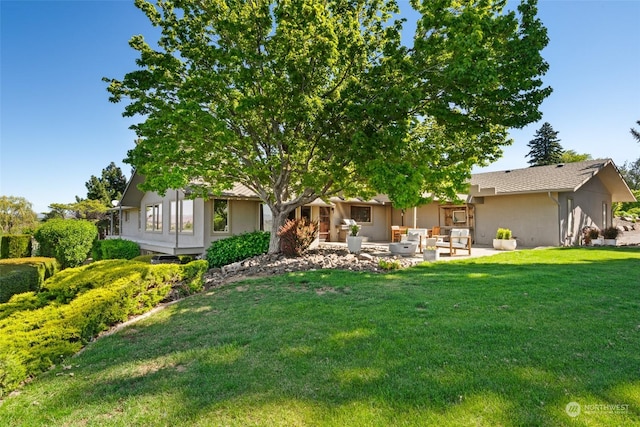 exterior space with a lawn, a patio, and an outdoor hangout area