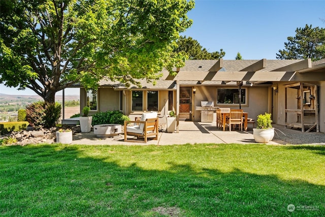 rear view of property with a lawn, area for grilling, and a patio