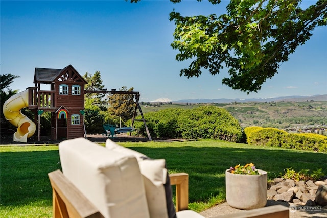 view of yard featuring a mountain view and a playground