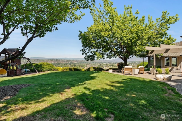 view of yard featuring a mountain view and a patio area