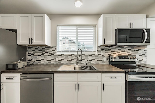 kitchen with decorative backsplash, appliances with stainless steel finishes, white cabinetry, and sink