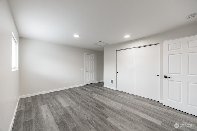 unfurnished bedroom featuring a closet and light wood-type flooring