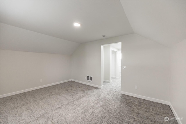 bonus room featuring carpet flooring and lofted ceiling