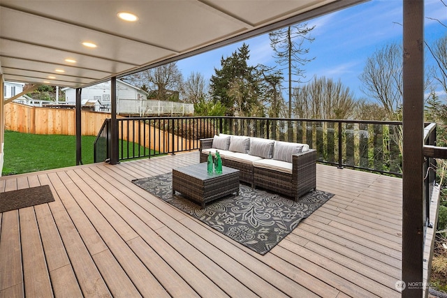 wooden deck with outdoor lounge area and a yard