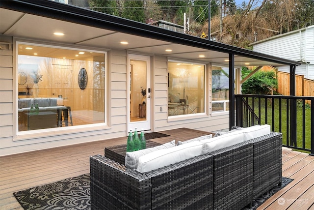 wooden terrace with an outdoor living space