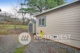 view of side of property featuring a shed