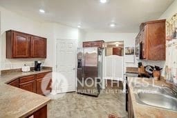 kitchen featuring sink and stainless steel fridge with ice dispenser