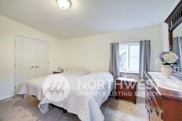 bedroom with lofted ceiling and a closet