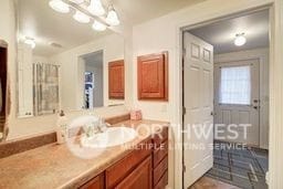 bathroom featuring vanity and a chandelier