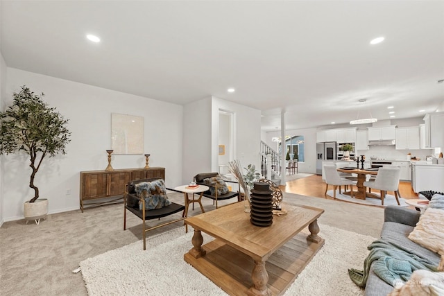 living room featuring light carpet and sink