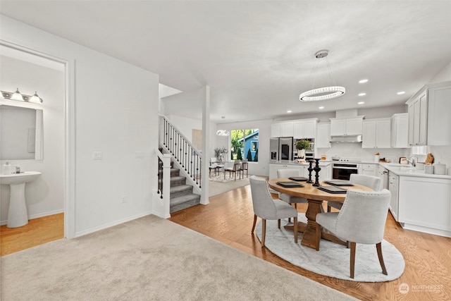 dining area featuring light hardwood / wood-style flooring and sink