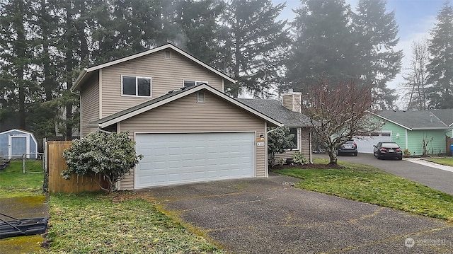 view of front property featuring a garage and a front yard