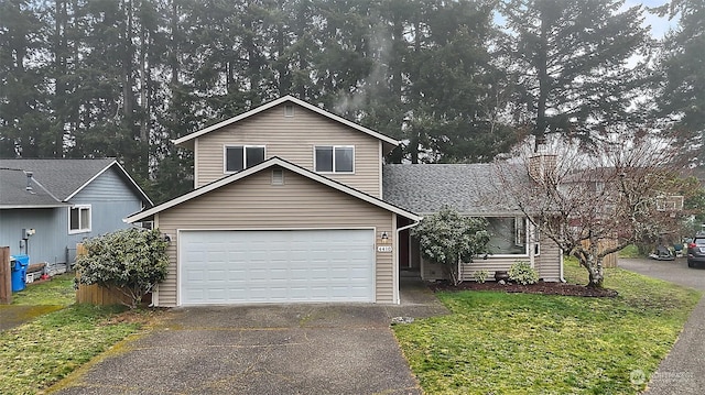 view of front property featuring a garage and a front lawn