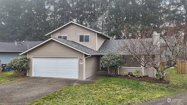 view of front property featuring a garage and a front lawn