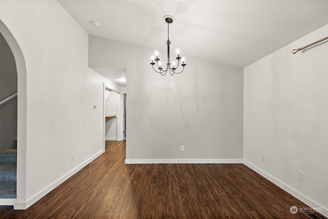 unfurnished dining area with a chandelier and dark hardwood / wood-style flooring