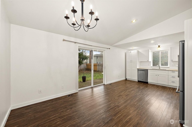 unfurnished dining area featuring vaulted ceiling, dark hardwood / wood-style flooring, sink, and an inviting chandelier