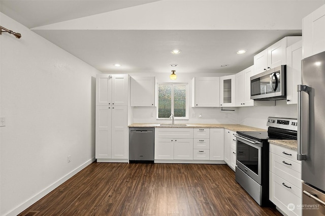 kitchen with dark hardwood / wood-style flooring, sink, stainless steel appliances, and white cabinets