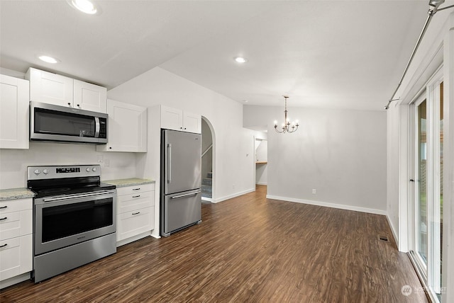 kitchen with white cabinetry, appliances with stainless steel finishes, and dark hardwood / wood-style floors