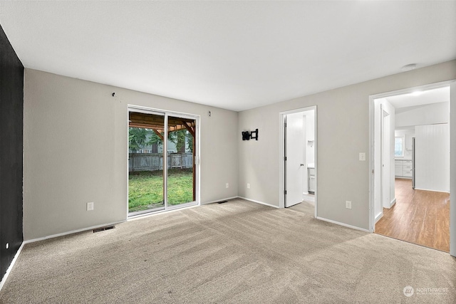 empty room featuring light colored carpet