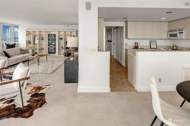 kitchen featuring light stone countertops and light parquet floors