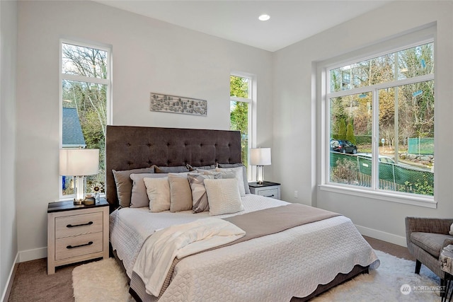 carpeted bedroom featuring recessed lighting and baseboards