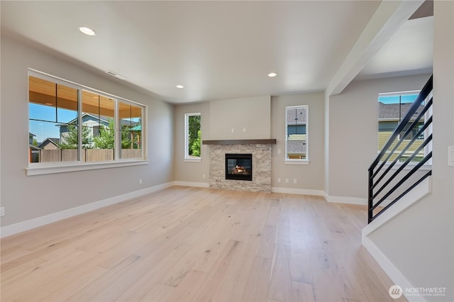 26521 NE 147th Pl Unit Sr 11, Duvall, WA 98019 - unfurnished living room with wood finished floors, healthy amount of natural light, baseboards, and recessed lighting