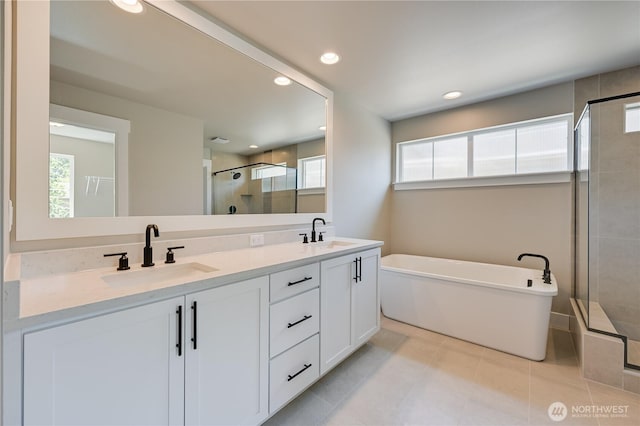 26521 NE 147th Pl Unit Sr 11, Duvall, WA 98019 - full bathroom featuring a shower stall, a freestanding bath, plenty of natural light, double vanity, and recessed lighting