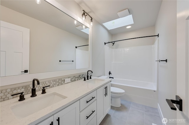 26521 NE 147th Pl Unit Sr 11, Duvall, WA 98019 - full bathroom featuring a skylight, toilet, double vanity, tile patterned flooring, and shower / tub combination