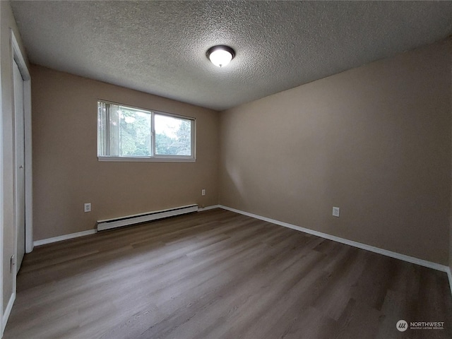 unfurnished bedroom with a baseboard heating unit, a textured ceiling, and hardwood / wood-style flooring