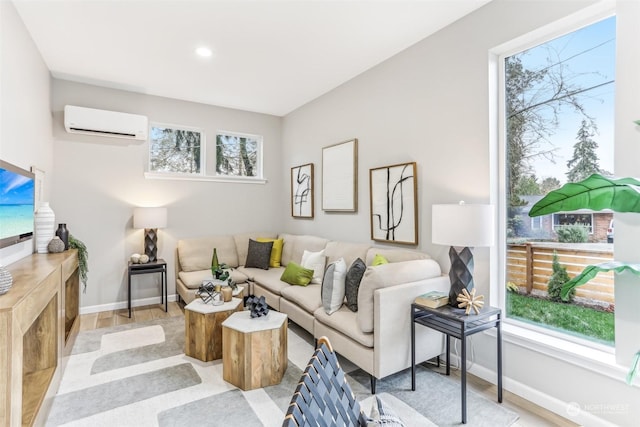 living room featuring a wall unit AC and light hardwood / wood-style floors