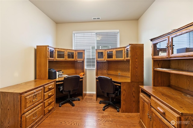 office area with light hardwood / wood-style floors