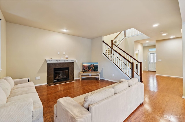 living room with hardwood / wood-style floors and a fireplace