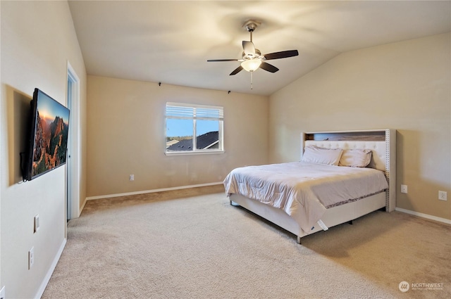 carpeted bedroom with vaulted ceiling and ceiling fan