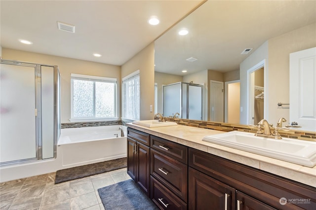 bathroom featuring vanity, tile patterned floors, and shower with separate bathtub