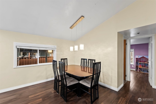 dining space featuring dark hardwood / wood-style floors and lofted ceiling