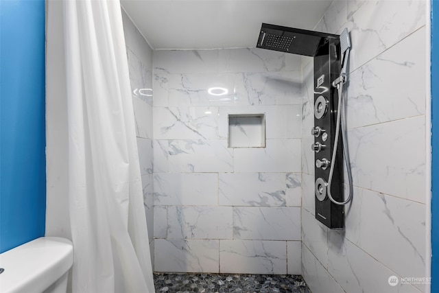 bathroom with toilet and walk in shower